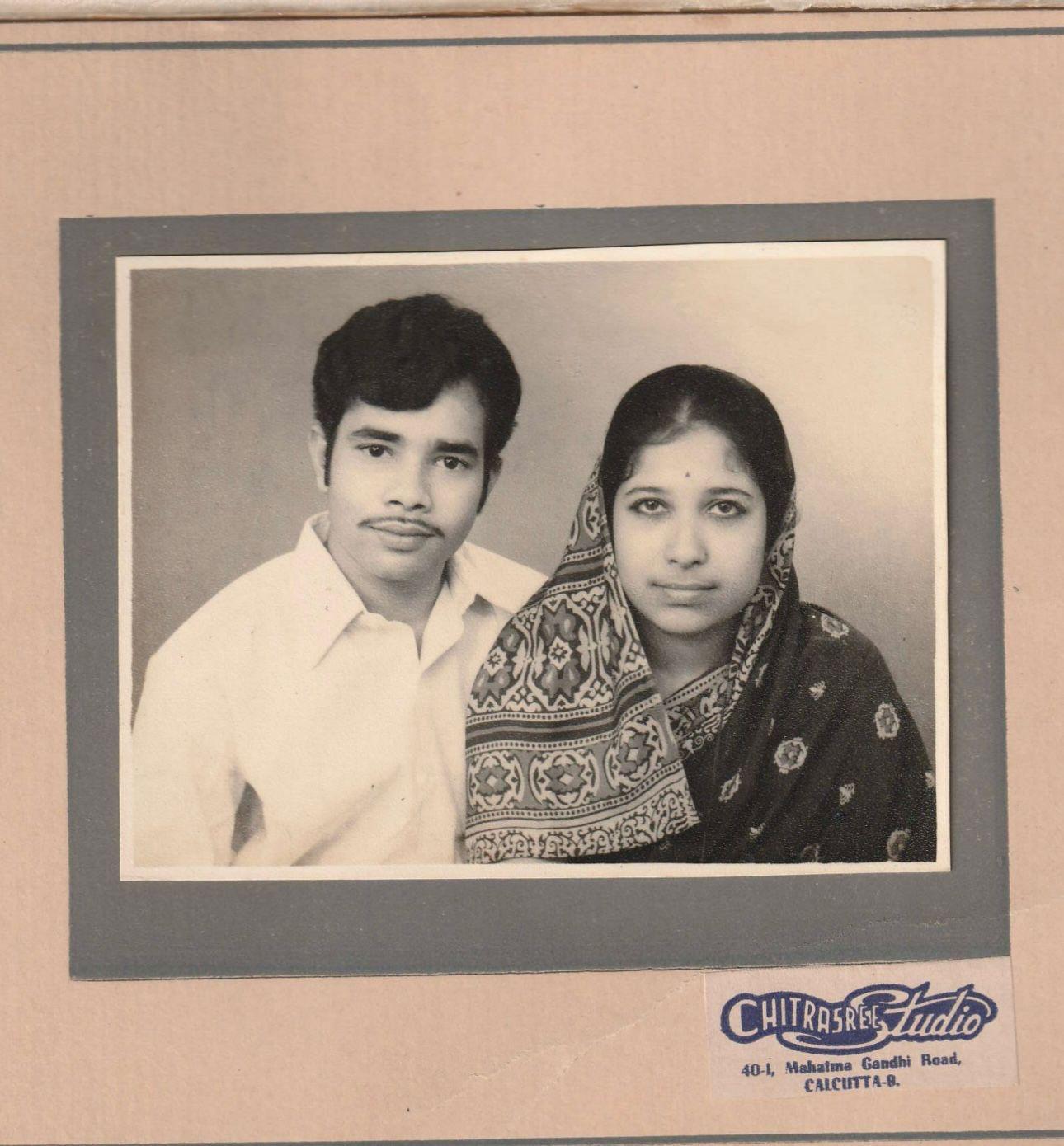 Black and white studio portrait of Rajat Nag Choudhury in a white shirt beside his new bride Bansari in a patterned sari, mounted in a Chitrasree Studio, Calcutta folder